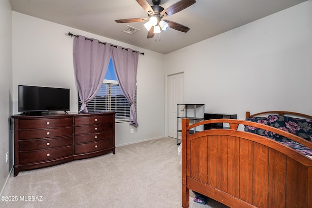 carpeted bedroom with ceiling fan, visible vents, and baseboards