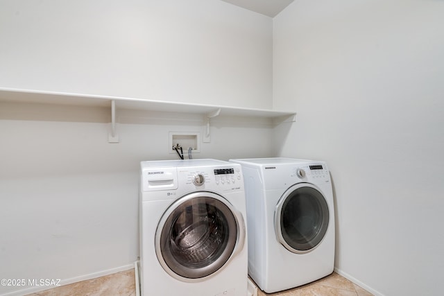 washroom featuring laundry area, washing machine and clothes dryer, and baseboards