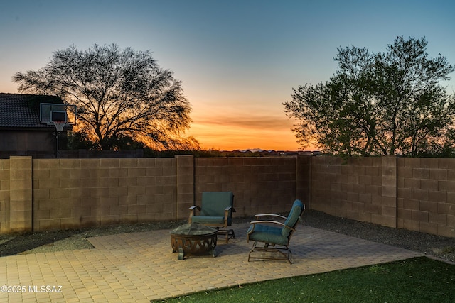 view of patio featuring an outdoor fire pit and fence