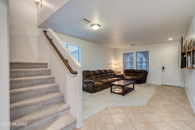 living area with visible vents, light colored carpet, stairs, light tile patterned flooring, and recessed lighting