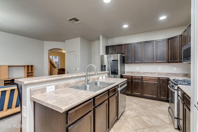 kitchen featuring visible vents, stainless steel appliances, a sink, and light countertops