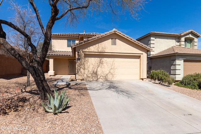 view of front of property featuring a tiled roof, stucco siding, an attached garage, and driveway