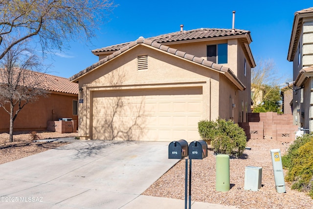 view of front of property featuring stucco siding, a tiled roof, concrete driveway, and a garage