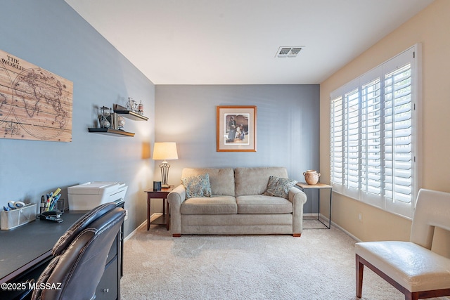 carpeted living area with visible vents and baseboards