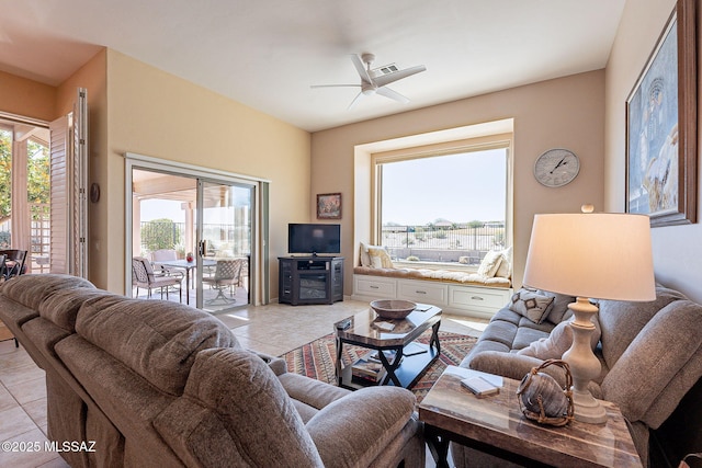 living room featuring light tile patterned floors and ceiling fan