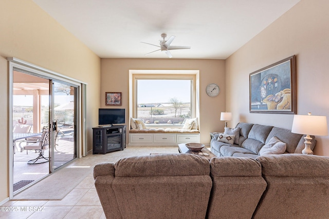 living area featuring light tile patterned floors and a ceiling fan