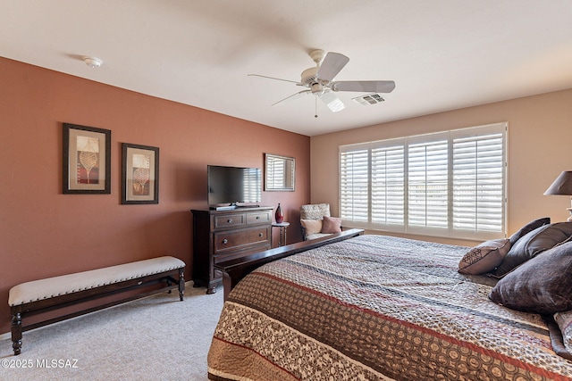 carpeted bedroom with ceiling fan and visible vents