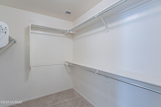 walk in closet featuring visible vents and carpet flooring