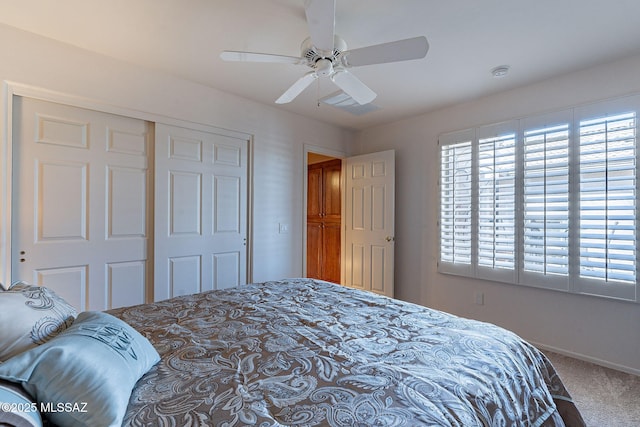 bedroom with a closet, a ceiling fan, and carpet flooring