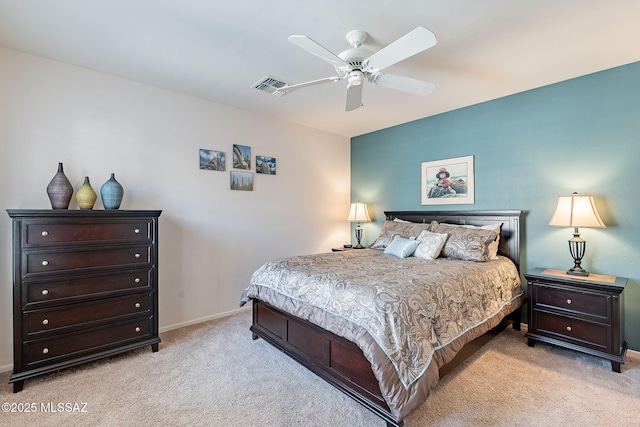 bedroom featuring light carpet, baseboards, visible vents, and a ceiling fan