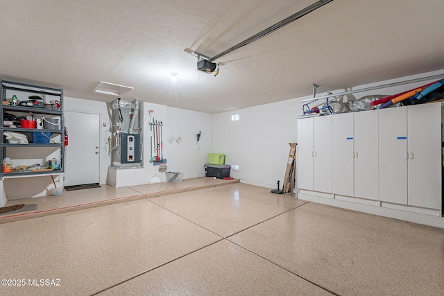 garage featuring heating unit and a garage door opener