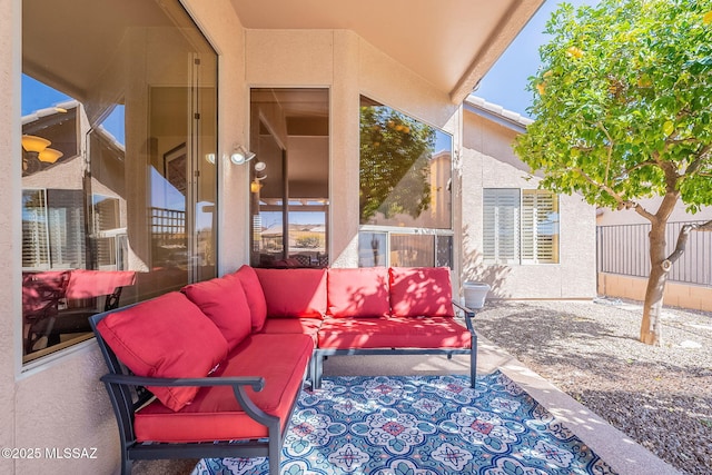 view of patio / terrace featuring outdoor lounge area and fence