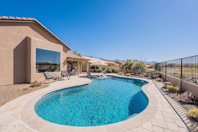 view of pool with fence, a pergola, a fenced in pool, and a patio