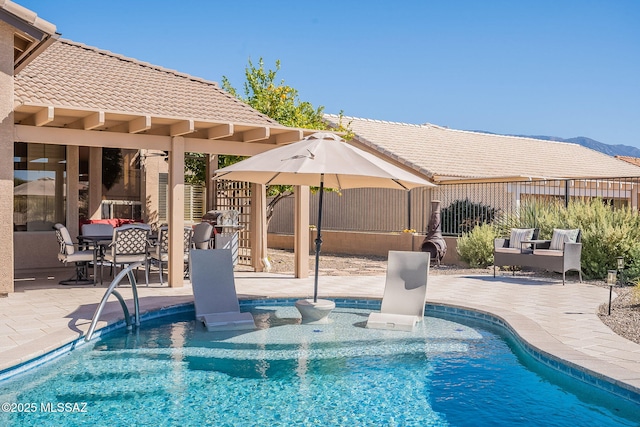 pool featuring a patio area and fence