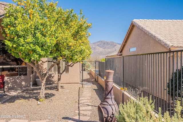 view of yard with a fenced backyard and a mountain view