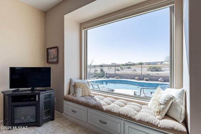 sitting room featuring a wealth of natural light and light tile patterned flooring