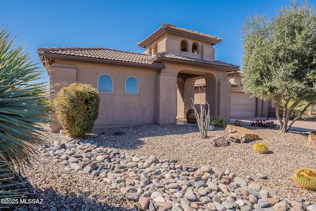 mediterranean / spanish home with a tile roof and stucco siding