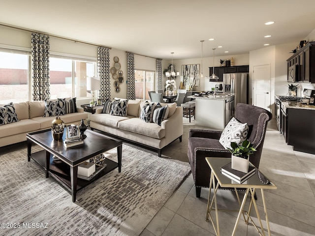 living room featuring recessed lighting, an inviting chandelier, and light tile patterned floors