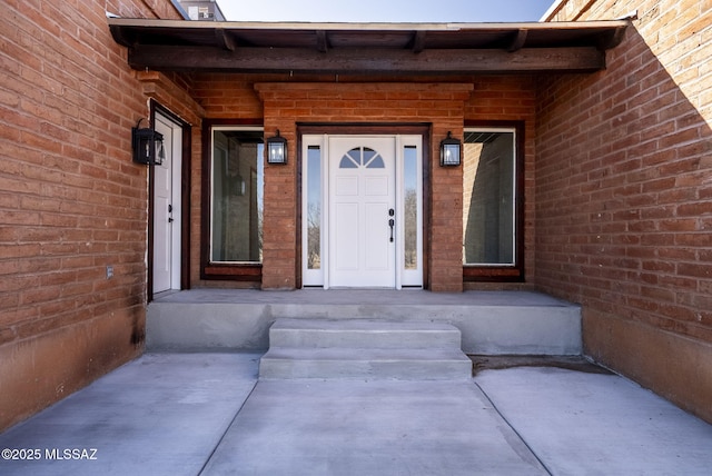 property entrance with brick siding