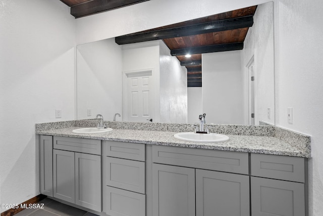 full bathroom with wooden ceiling, a sink, beamed ceiling, and double vanity