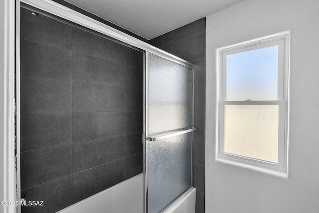 full bathroom featuring bath / shower combo with glass door