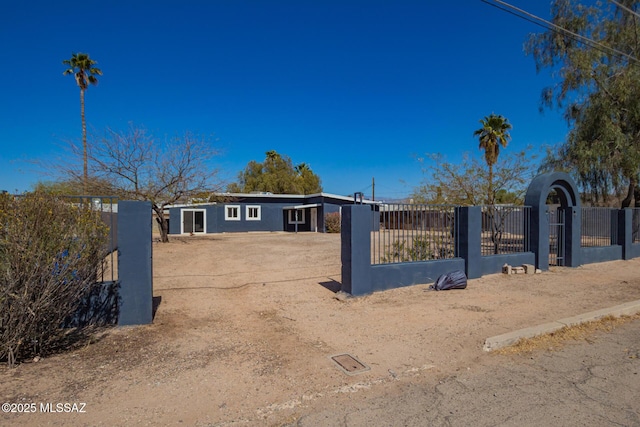 view of front of property featuring a fenced front yard and a gate