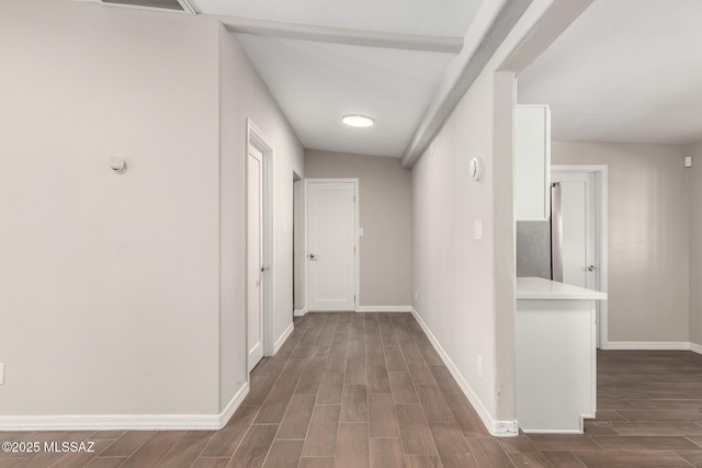 corridor featuring baseboards and wood tiled floor