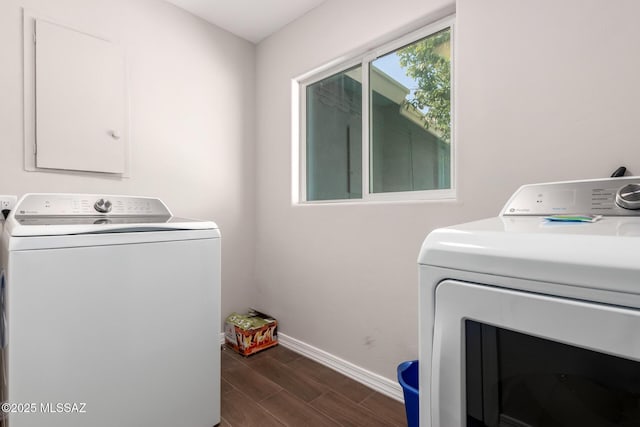 washroom featuring laundry area, dark wood finished floors, washer and dryer, and baseboards