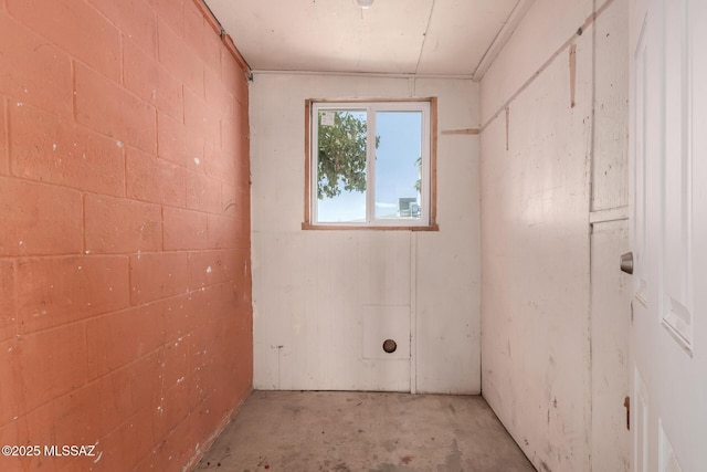 empty room with concrete block wall and concrete floors