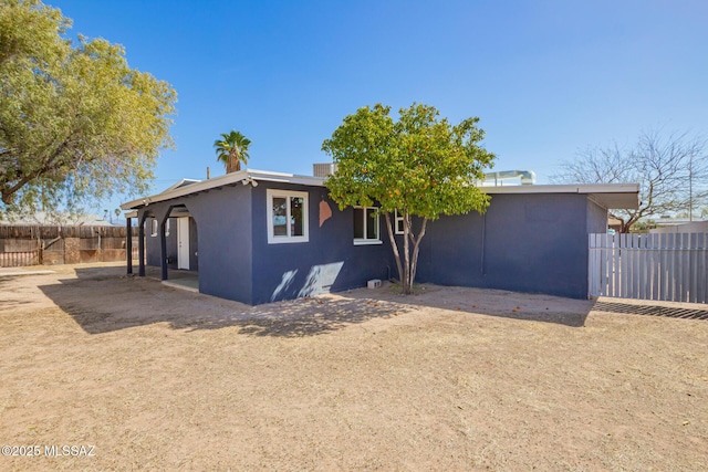 exterior space with fence and stucco siding