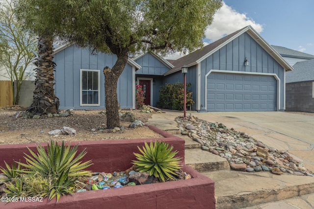 view of front facade with board and batten siding, driveway, and an attached garage