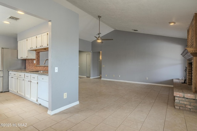 kitchen with visible vents, dishwasher, ceiling fan, a sink, and freestanding refrigerator