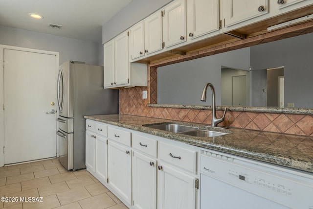 kitchen with a sink, visible vents, dishwasher, and white cabinetry