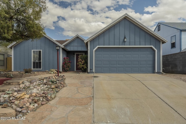 view of front of house with driveway, a garage, and board and batten siding