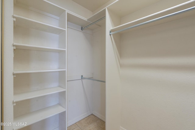walk in closet featuring tile patterned flooring