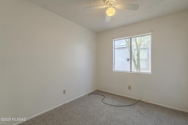 carpeted spare room featuring a ceiling fan, baseboards, and a textured ceiling
