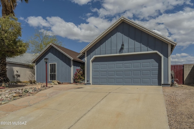 view of front facade featuring board and batten siding, driveway, and a garage