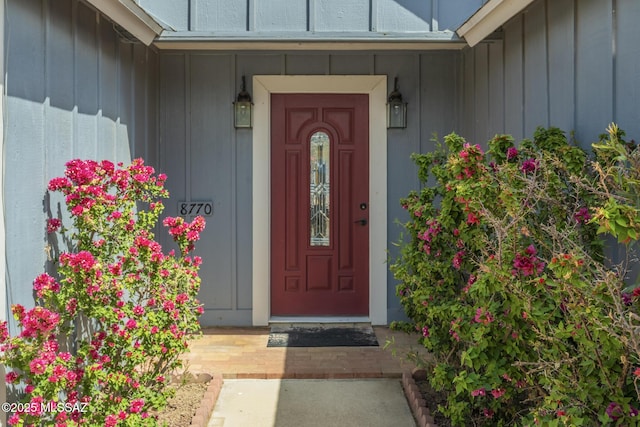 view of exterior entry featuring board and batten siding