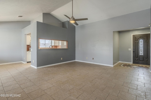 unfurnished living room featuring lofted ceiling, light tile patterned floors, baseboards, visible vents, and ceiling fan