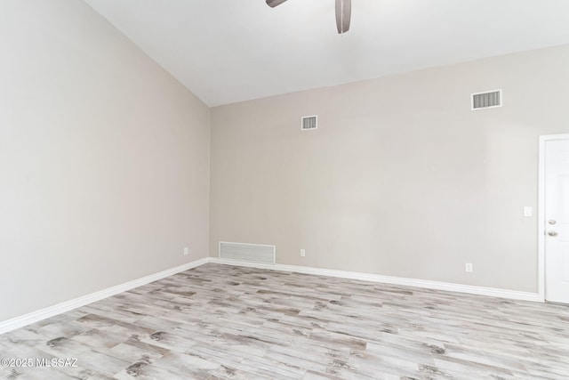 spare room featuring visible vents, baseboards, and light wood-style floors