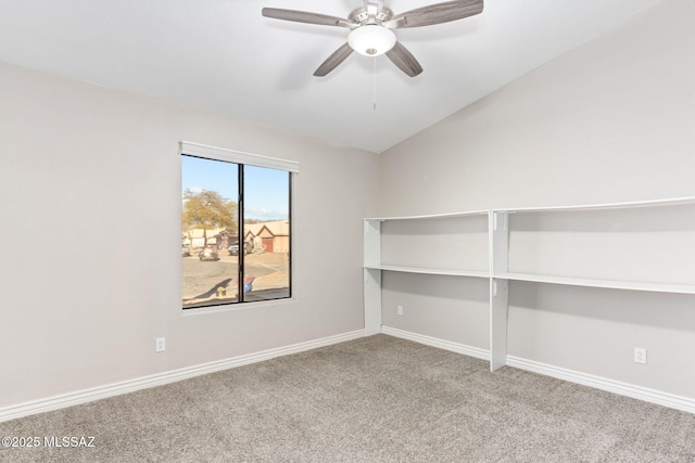 carpeted spare room with baseboards, lofted ceiling, and a ceiling fan