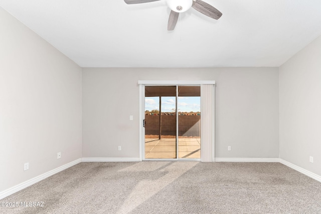 unfurnished room featuring baseboards, carpet floors, and a ceiling fan