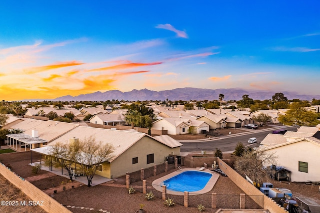 aerial view at dusk with a mountain view and a residential view