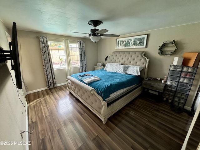 bedroom featuring ceiling fan, baseboards, and wood finished floors