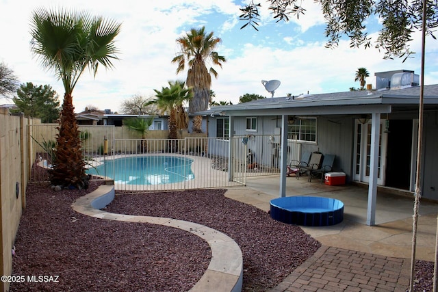 view of pool with a fenced in pool, a fenced backyard, and a patio