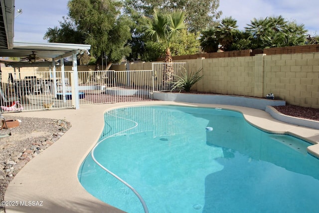 view of pool with a fenced backyard, ceiling fan, a fenced in pool, and a patio