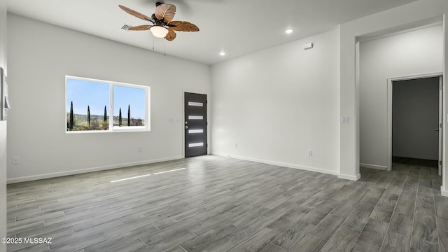spare room with ceiling fan, baseboards, wood finished floors, and recessed lighting