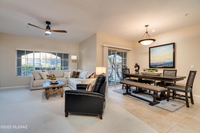 living room featuring light tile patterned floors, ceiling fan, and baseboards