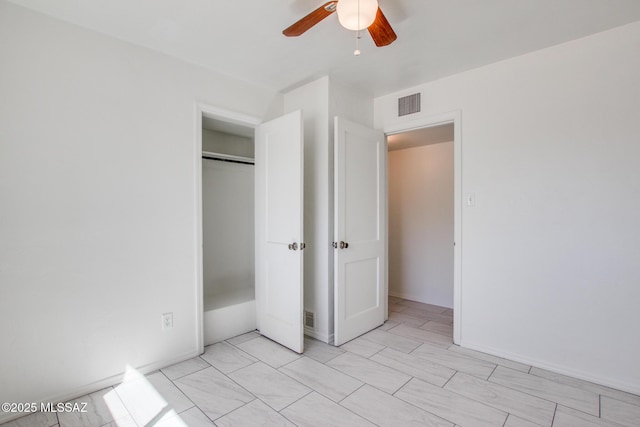 unfurnished bedroom featuring a closet, visible vents, and a ceiling fan