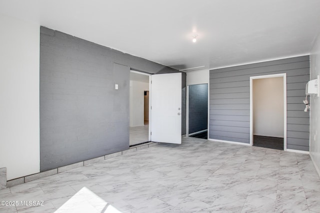 unfurnished bedroom with marble finish floor